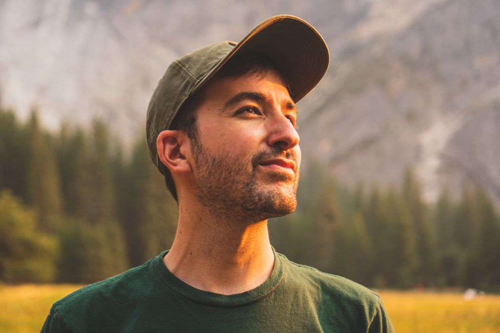 Reviewer profile picture: man in a baseball cap looking up, blurred landscape in the background.